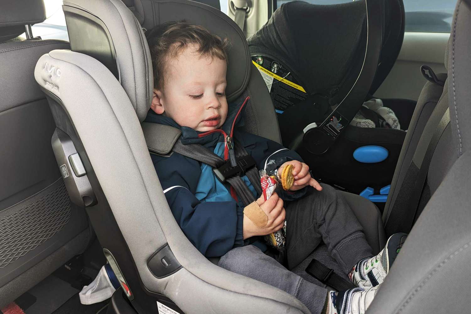 Child sitting in the Nuna Rava Convertible Car Seat