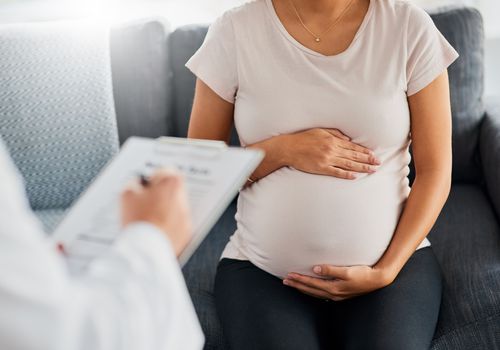 Shot of a pregnant young woman at appointment with doctor