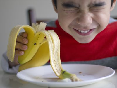 Boy eating banana