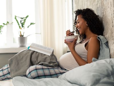 woman in bed eating